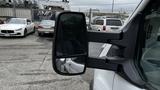 A 2017 Ford Transit van with a large side mirror showcasing its design and structure