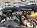 A 2010 Ford F-550 engine compartment showcasing various components including the turbocharger and coolant reservoir