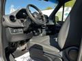 Interior view of a 2021 Mercedes-Benz Sprinter showcasing the driver's seat and steering wheel with dashboard controls visible