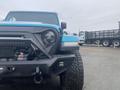 A blue 2020 Jeep Wrangler with a rugged front design and off-road tires is prominently displayed in the foreground