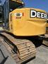 A yellow 2009 John Deere 135 D excavator with a prominent logo and large tracks designed for heavy machinery operations