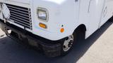 A white 2011 Ford Econoline van with a boxy shape and a slightly damaged front bumper displaying yellow turn signal lights and a prominent grille