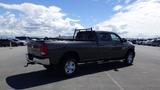 A 2014 RAM 3500 pickup truck with a gray exterior and a truck bed rack parked in a lot