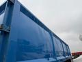 A blue 2011 Freightliner Cascadia Nordic truck with a smooth surface and cargo area visible from a low angle