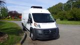 A white 2017 RAM Promaster van parked with a roof-mounted air conditioning unit and a large cargo area