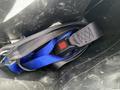 A 2017 Chevrolet Express seatbelt secured in a black nylon bag featuring a blue strap and a red release button