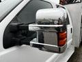 Close-up of a chrome side mirror on a 2014 Ford F-550 with raindrops on the surface