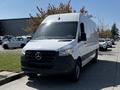 A 2022 Mercedes-Benz Sprinter van with a white exterior and a black front grille parked on a street