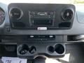 Interior dashboard of a 2022 Mercedes-Benz Sprinter featuring a radio display climate controls and cup holders