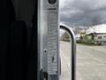A 2014 Kenworth T370 door with a metal handle and an attached specification label listing various vehicle details