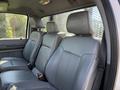 Interior view of a 2016 Ford F-350 SD showing gray leather seats in the front row with headrests and seat belts