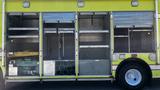 A 1995 Freightliner FLL086 fire truck with yellow exterior featuring multiple storage compartments and equipment racks on the side