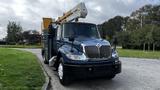 A blue 2009 International 4300 truck with an elevated bucket on top and a utility body designed for overhead work