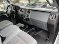 Interior of a 2014 Ford F-550 featuring gray fabric seats and a dashboard labeled Super Duty with controls and a music system visible