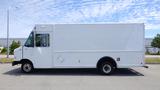 White 2011 Ford Econoline cargo van side view with a boxy shape and large cargo area on the body