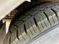 Close-up of a tire from a 2015 Chevrolet Express showing tread pattern and surface details