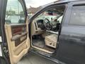 A 2010 Dodge Ram with an open driver's side door showing the interior featuring leather seats and a center console