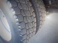 Close-up of the tread on a tire from a 2013 Mitsubishi Fuso FE 160 showcasing its deep grooves and rugged texture