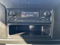 Dashboard display of a 2021 Mercedes-Benz Sprinter showing radio controls and a digital clock