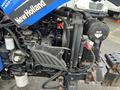 A 2007 New Holland TN70A tractor engine with exposed components including the air filter and various hoses and cables