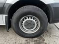 A close-up of a silver wheel and tire of a 2016 Mercedes-Benz Sprinter showing the rim and tire pattern