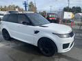 A white 2020 Land Rover Range Rover Sport with black accents and large black wheels is parked in a lot