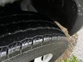 Close-up of a wet tire from a 2018 RAM Promaster showcasing the tread pattern and water droplets on the surface