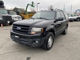 Black 2017 Ford Expedition with a front grille featuring the Ford logo and chrome accents parked in a lot