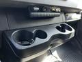 Interior view of a 2022 Mercedes-Benz Sprinter showing a console with cup holders and control panel mounted above