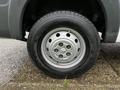 Close-up of a silver wheel with multiple bolt holes mounted on a 2018 RAM Promaster