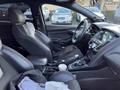 Interior of a 2018 Ford Focus showing black leather seats and a dashboard with control panels and a gear shifter