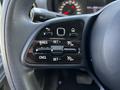 Close-up of a steering wheel control panel featuring buttons for cruise control with indicators for resume, set, and cancel functions