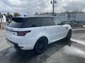 A 2020 Land Rover Range Rover Sport in white with a black roof and black wheels parked at an outdoor location