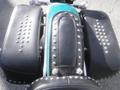 A 2009 Harley-Davidson FLSTC showing a top view of the leather seat and studded saddlebags on either side