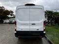 A white 2021 Ford Transit van viewed from the rear with a logo and model name clearly visible on the back doors