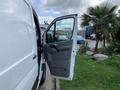 A 2017 Mercedes-Benz Sprinter van with its front door open, revealing the interior and driver's seat