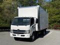 A 2020 Hino 195 box truck featuring a white exterior and a large cargo area with a silver rear door