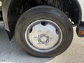 Close-up of the tire and wheel assembly of a 2020 Hino 195 with a metallic rim and a sturdy tread pattern