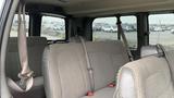 Interior view of a 2017 Chevrolet Express Quigley 4x4 showing three rows of seating with seatbelts attached