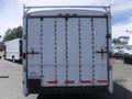 A white 2010 Forest River enclosed trailer with a rear double door and multiple locking mechanisms visible on the surface