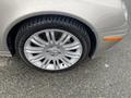 A close-up view of a silver 2007 Mercedes-Benz E-Class wheel with a multi-spoke alloy rim and a Michelin tire