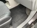 A black rubber floor mat with a honeycomb pattern inside the front passenger area of a 2013 Toyota Sienna