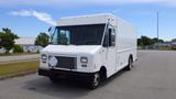 A white 2011 Ford Econoline cargo van with a boxy shape and large windshield parked on a paved surface