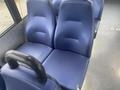 Two blue fabric seats with a textured surface designed for comfort located in a vehicle interior