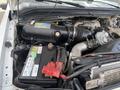 Close-up of the engine compartment of a 2010 Ford F-550 featuring the engine components battery and hoses