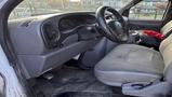 Interior of a 2002 Ford Econoline showing the driver's seat steering wheel and dashboard with gray upholstery