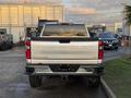 A 2023 Chevrolet Silverado 3500HD displayed from the rear showing its distinctive tailgate and chrome detailing