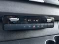 A control panel for climate settings in a 2022 Mercedes-Benz Sprinter featuring temperature dials air conditioning and various function buttons