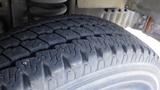 Close-up view of a tire from a 2011 Ford Econoline showing tread patterns and sidewall detail