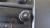 A close-up of a music control knob in a 2012 GMC Savana with a music note icon on it